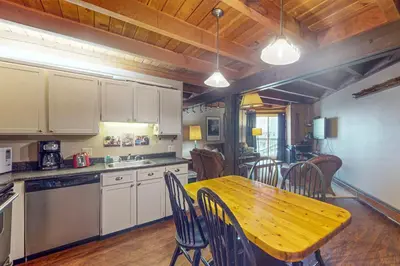a kitchen with a wooden table and chairs in it at Lodgepole Landing in Silverthorne