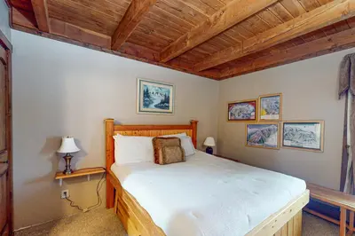 a bedroom with a bed and a wooden ceiling at Lodgepole Landing in Silverthorne