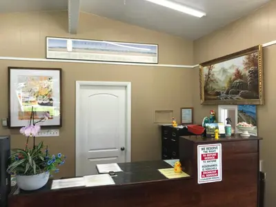 an office with a desk and a sign on the wall at Lamplighter Motel in Longmont