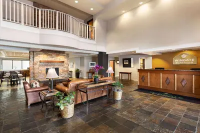 a lobby of a hotel with couches and a desk at Wingate by Wyndham Denver Tech Center in Greenwood Village