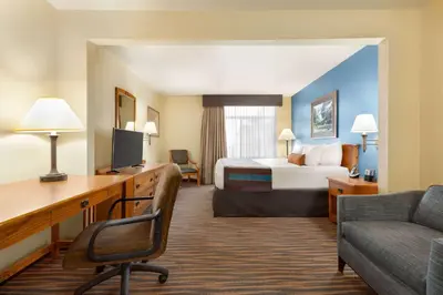 a hotel room with a bed and a desk at Wingate by Wyndham Denver Tech Center in Greenwood Village