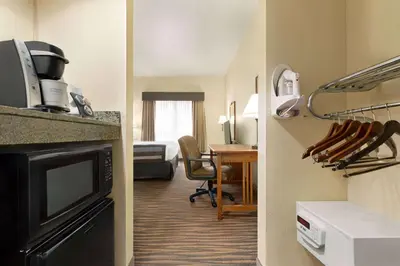 a hotel room with a kitchen and a living room at Wingate by Wyndham Denver Tech Center in Greenwood Village