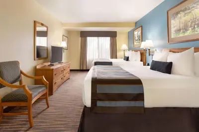 a hotel room with two beds and a television at Wingate by Wyndham Denver Tech Center in Greenwood Village