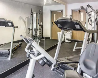 a gym with a treadmill and a mirror at Quality Inn Louisville - Boulder in Louisville