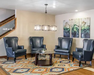 a waiting room with leather chairs and a table at Quality Inn Louisville - Boulder in Louisville