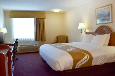 a hotel room with a large bed and a desk at Quality Inn Louisville - Boulder in Louisville