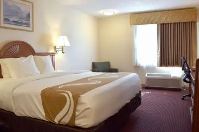 a hotel room with a large bed and a window at Quality Inn Louisville - Boulder in Louisville