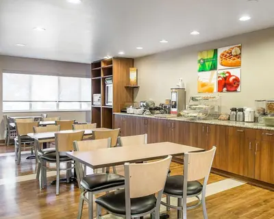 a restaurant with tables and chairs and a counter at Quality Inn Louisville - Boulder in Louisville