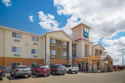 a hotel with cars parked in a parking lot at Best Western Firestone Inn & Suites in Longmont