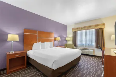 a hotel room with a large bed and a window at Best Western Firestone Inn & Suites in Longmont