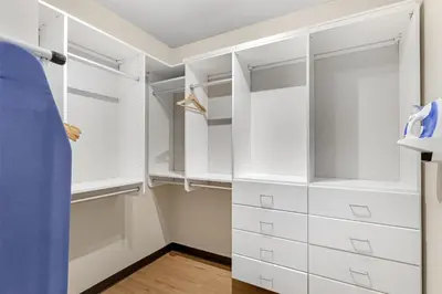 a walk in closet with white cabinets at Best Western Firestone Inn & Suites in Longmont