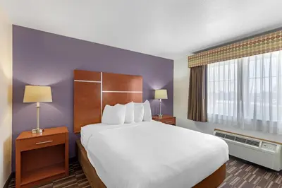a hotel room with a large bed and a window at Best Western Firestone Inn & Suites in Longmont