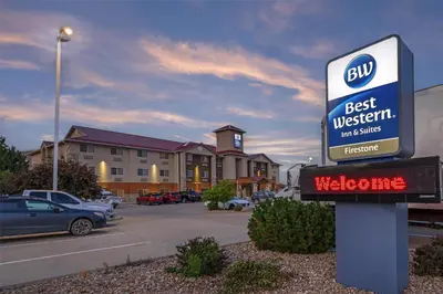 a best western sign in a parking lot at Best Western Firestone Inn & Suites in Longmont