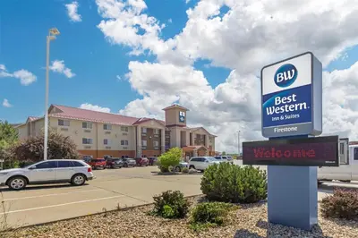 a sign in front of a best western inn suites at Best Western Firestone Inn & Suites in Longmont