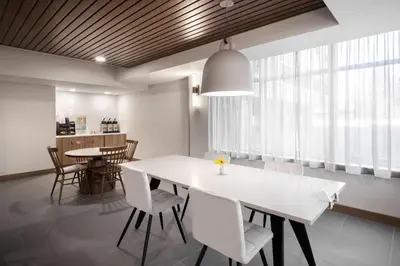 a dining room with a white table and chairs at Fairfield Inn & Suites Boulder in Boulder