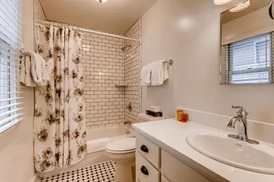a bathroom with a sink and a toilet and a shower at Colorado Chautauqua Cottages in Boulder