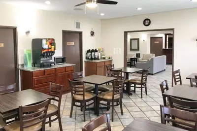 a restaurant with tables and chairs in a room at Quality Inn Denver Westminster in Westminster