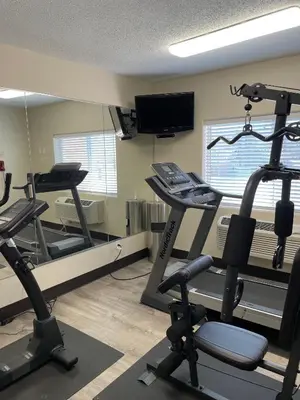 a gym with two tread machines and a mirror at Quality Inn Denver Westminster in Westminster