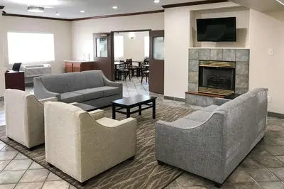 a living room with couches and a fireplace at Quality Inn Denver Westminster in Westminster