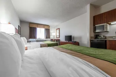 a hotel room with two beds and a television at Quality Inn Denver Westminster in Westminster
