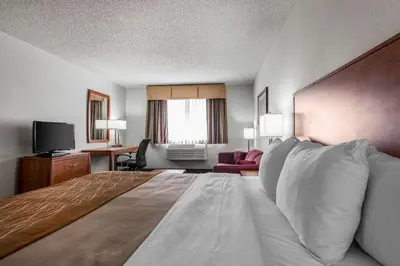 a hotel room with a bed and a television at Quality Inn Denver Westminster in Westminster