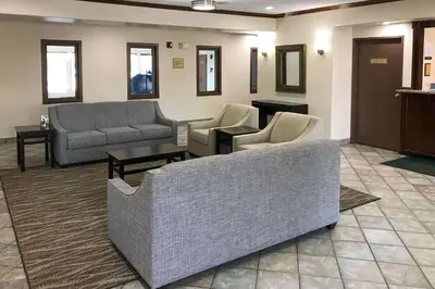 a waiting room with couches and tables and mirrors at Quality Inn Denver Westminster in Westminster
