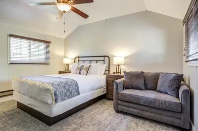 a bedroom with a bed and a couch at Grand Lake Lodge in Grand Lake