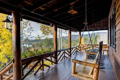 a porch with a swing and a view at Grand Lake Lodge in Grand Lake