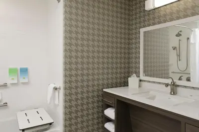 a bathroom with a sink and a mirror at Home2 Suites By Hilton Fort Collins in Fort Collins