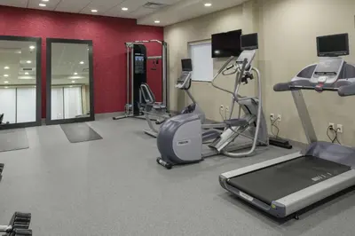 a gym with cardio equipment and a treadmill at Home2 Suites By Hilton Fort Collins in Fort Collins