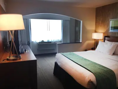 a hotel room with a bed and a window at Holiday Inn Express Hotel & Suites Fraser Winter Park Area by IHG in Fraser