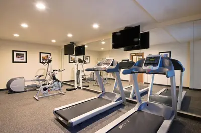a gym with treadmills and elliptical machines at Holiday Inn Express Hotel & Suites Fraser Winter Park Area by IHG in Fraser