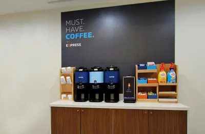 a counter with bottles of coffee on it at Holiday Inn Express Hotel & Suites Fraser Winter Park Area by IHG in Fraser