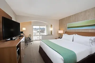 a hotel room with a bed and a flat screen tv at Holiday Inn Express Hotel & Suites Fraser Winter Park Area by IHG in Fraser