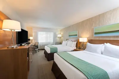 a hotel room with two beds and a flat screen tv at Holiday Inn Express Hotel & Suites Fraser Winter Park Area by IHG in Fraser