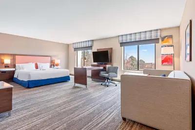 a hotel room with a bed and a desk at Hampton Inn & Suites Greeley in Greeley