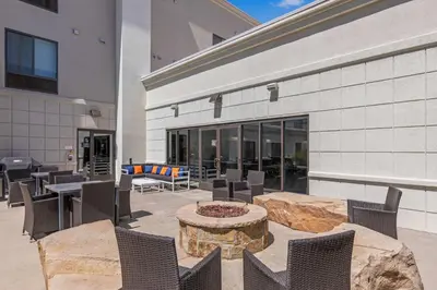 a patio with chairs and a fire pit in front of a building at Hampton Inn & Suites Greeley in Greeley