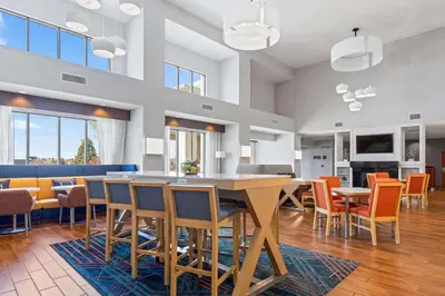 a dining room with a table and chairs at Hampton Inn & Suites Greeley in Greeley