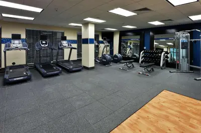 a gym with several treadmills and cardio machines at Hampton Inn & Suites Denver Airport / Gateway Park in Denver