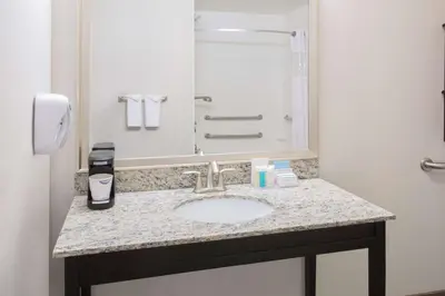 a bathroom with a sink and a mirror at Hampton Inn & Suites Denver Airport / Gateway Park in Denver