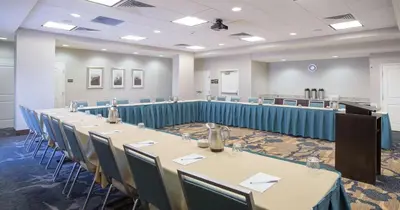 a conference room with long tables and chairs at Hampton Inn & Suites Denver Airport / Gateway Park in Denver