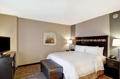 a hotel room with a bed and a flat screen tv at Hampton Inn & Suites Denver Airport / Gateway Park in Denver