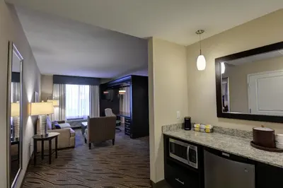 a hotel room with a living room with a living room at Hampton Inn & Suites Denver Airport / Gateway Park in Denver