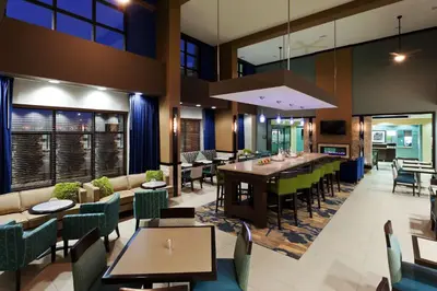 a restaurant with tables and chairs and a dining room at Hampton Inn & Suites Denver Airport / Gateway Park in Denver