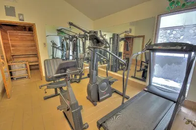 a fitness room with a gym with a treadmill at Dillon Inn in Dillon