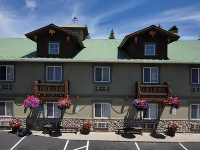 a building with benches and flowers in front of it at Dillon Inn in Dillon