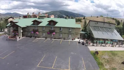 an empty parking lot in front of a large building at Dillon Inn in Dillon
