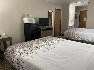 a hotel room with two beds and a television at Dillon Inn in Dillon
