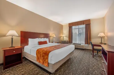 a hotel room with a large bed and a desk at Best Western Plus Boulder Louisville in Louisville