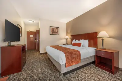 a hotel room with a bed and a flat screen tv at Best Western Plus Boulder Louisville in Louisville